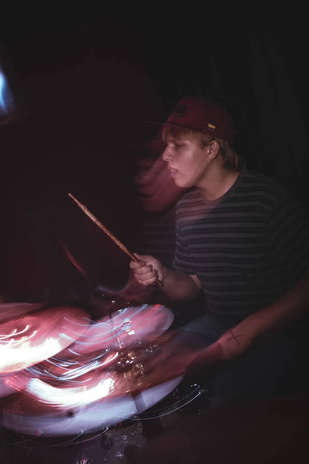 Max playing drums in a long-exposure action shot