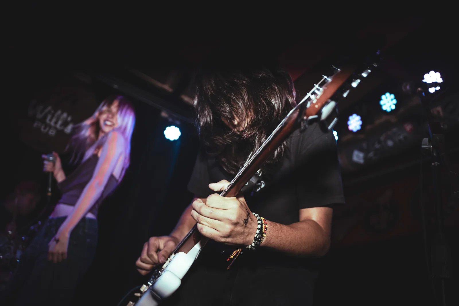 Close-up of guitar playing during the Will’s Pub show
