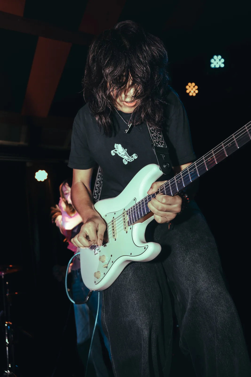 Guitarist performing under the Will’s Pub stage lights